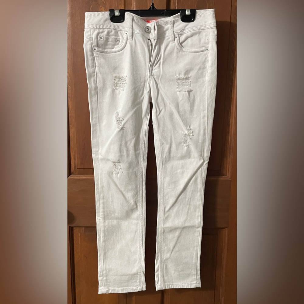 Distressed white low rise jeans.